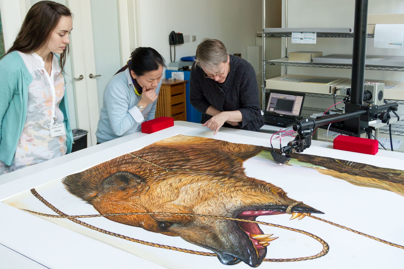 Left to right: Advanced conservation intern Heather Brown, works on paper conservator Tina Tan, and research scientist Cory Rogge discuss the artist’s palette.