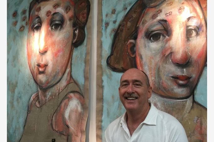 Patrick Palmer headshot w/paintings