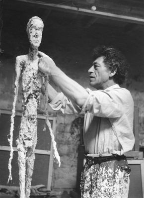 Ernst Scheidegger, Alberto Giacometti Working on the Plaster of the “Walking Man,” c. 1959, silver print on paper