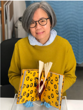 Tina Tan, conservator, works on paper